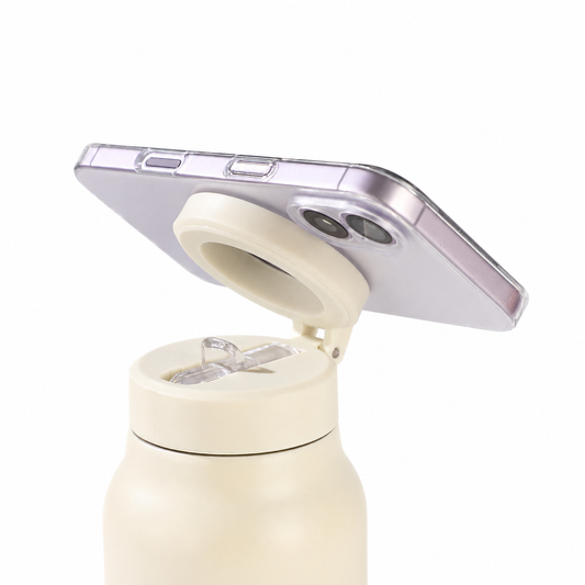 Close-up of a phone attached to the magnetic holder on the FlowMount bottle lid